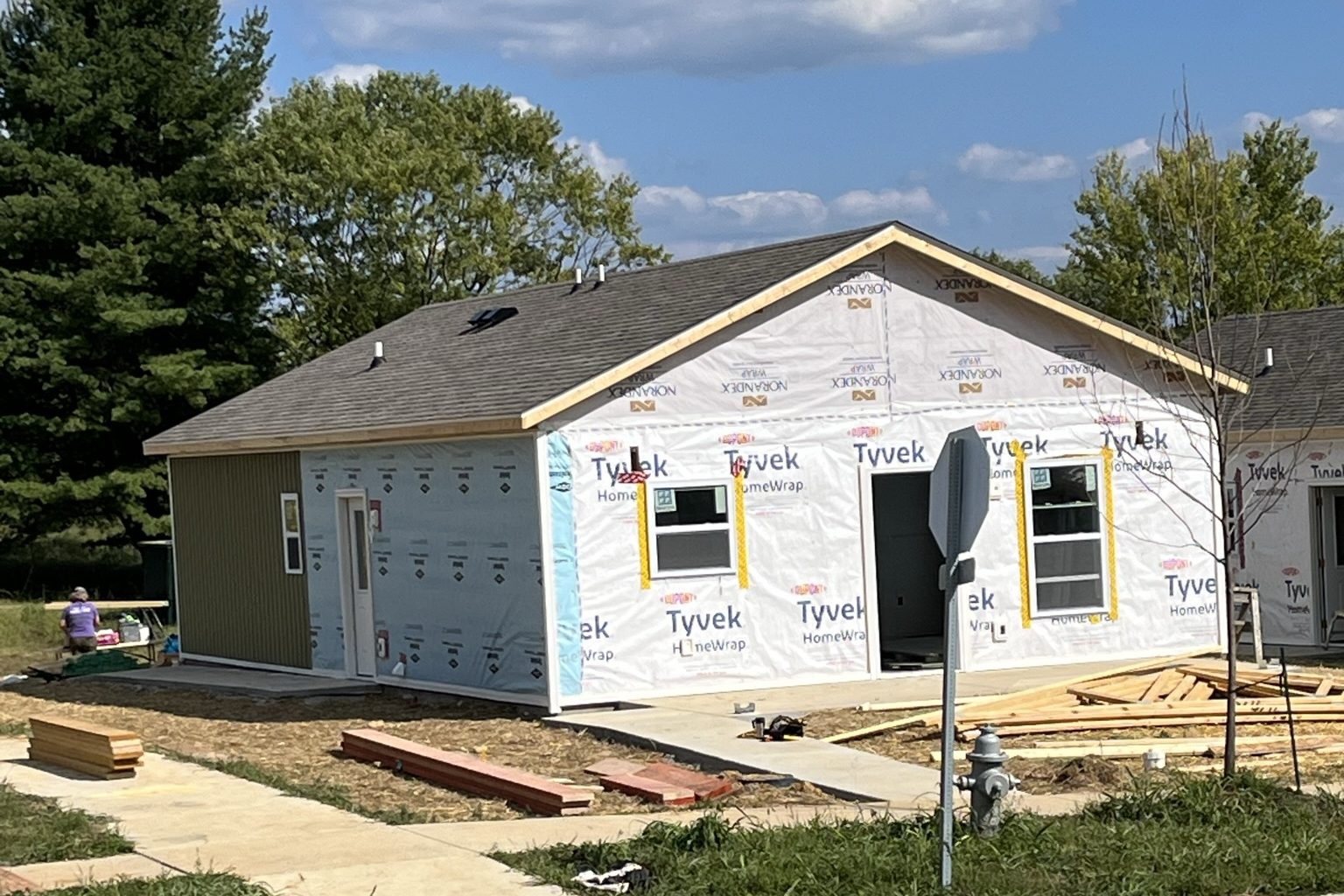 a partially constructed home with green siding